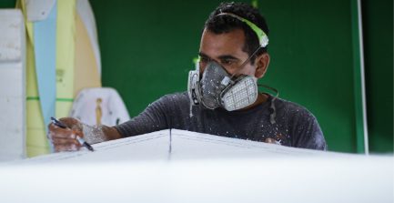 Man in a respirator drawing on a project